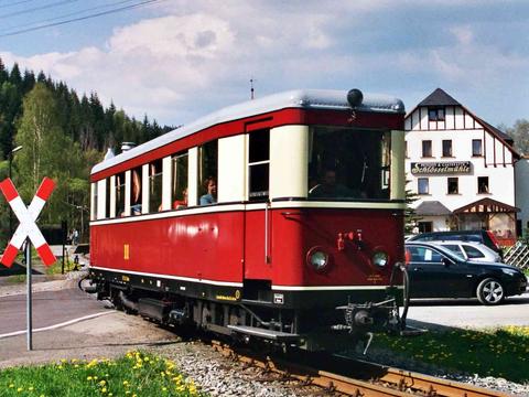 Der Triebwagen aus Zittau quert den Bahnübergang in Schlössel