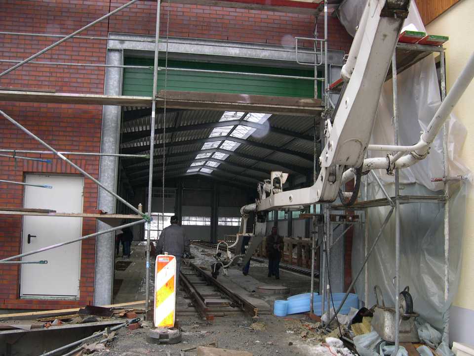 Der Ausleger der Betonpumpe ragt in die Fahrzeughalle hinein. Mit ihr sollen heute rund 200 m³ Beton als Hallenfußboden eingebracht werden.