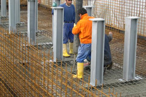 Die Stahlbewehrung des Fußbodens wird mit Beton aufgefüllt.